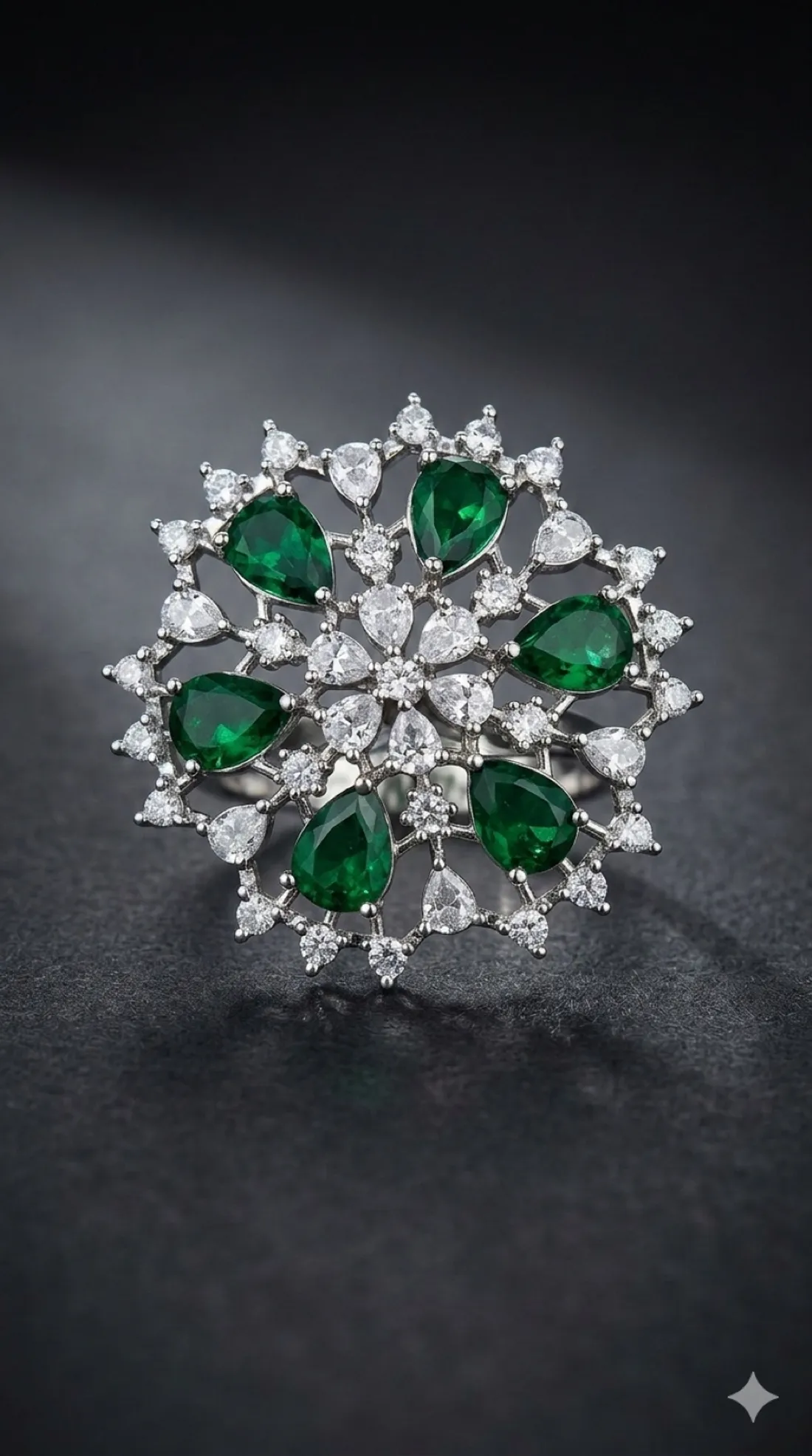 A silver-toned cocktail ring with green and clear stones
