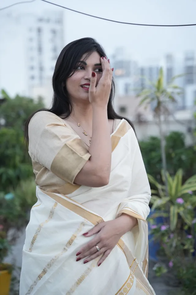 Founder Rashmi wearing a cream-and-gold saree