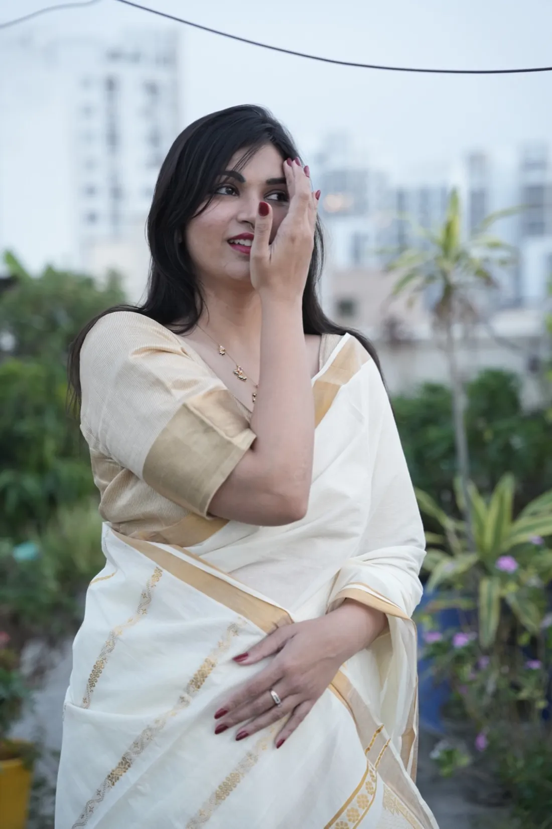 Founder Rashmi wearing a cream-and-gold saree
