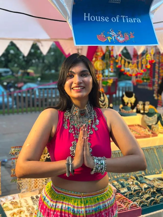 Founder Rashmi at a House of Tiara exhibition stall, hands folded in namaste