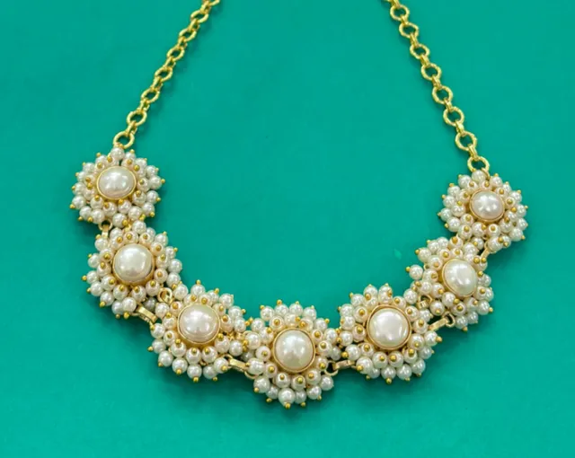 A pearl-and-gold floral necklace with matching studs