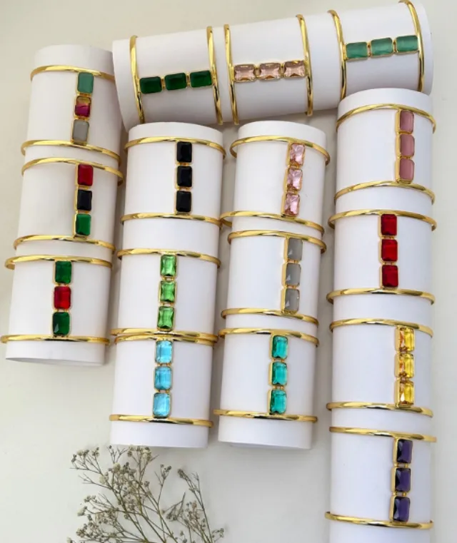 Rows of gold bangles set with colourful stones