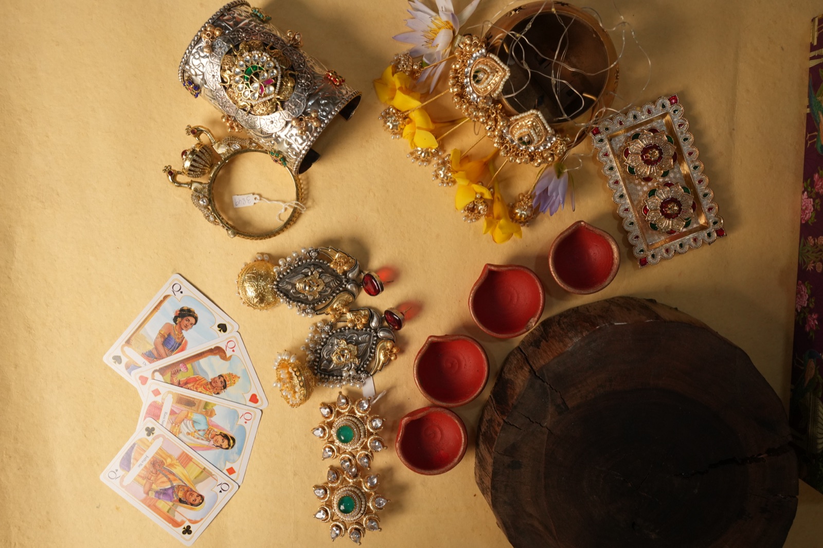 A Karva Chauth flat lay with diyas and festive jewellery