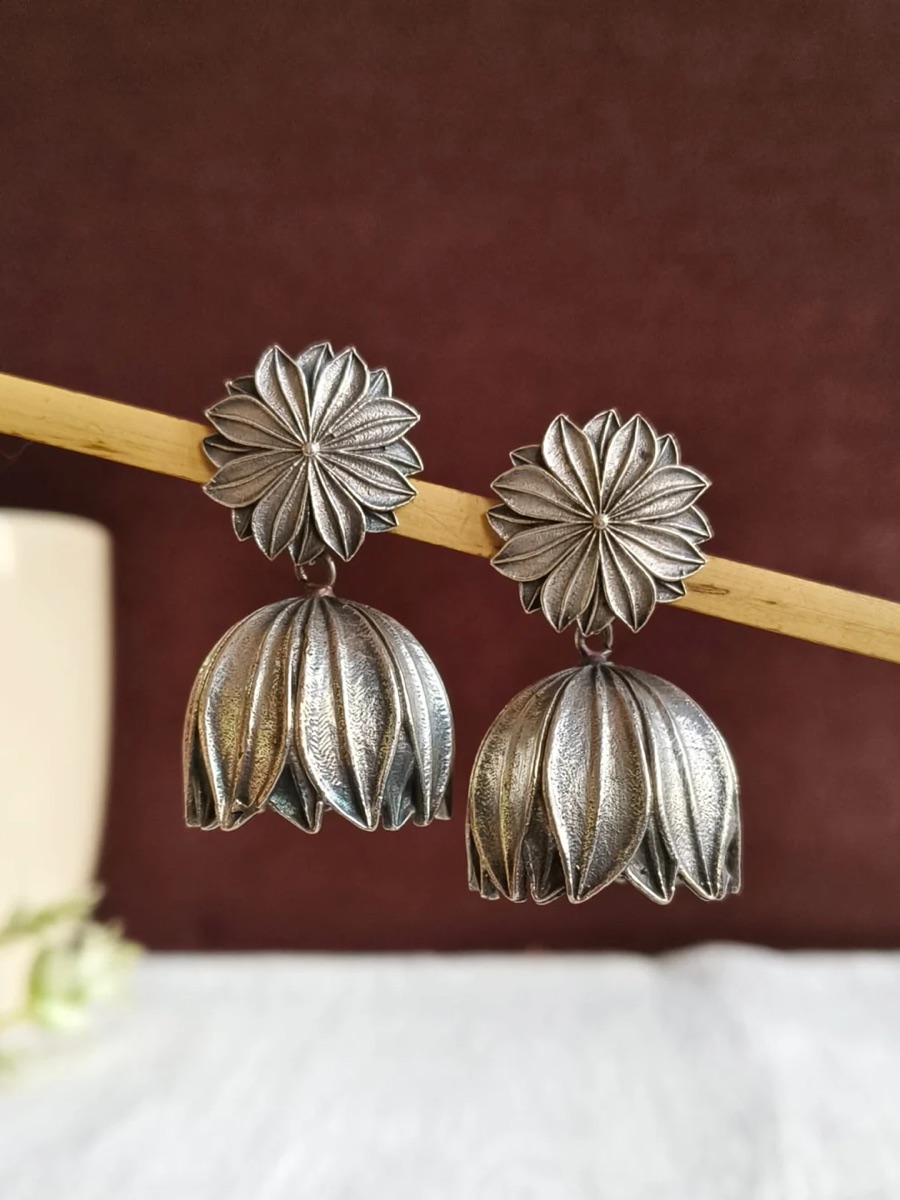 A pair of oxidised silver floral jhumka earrings